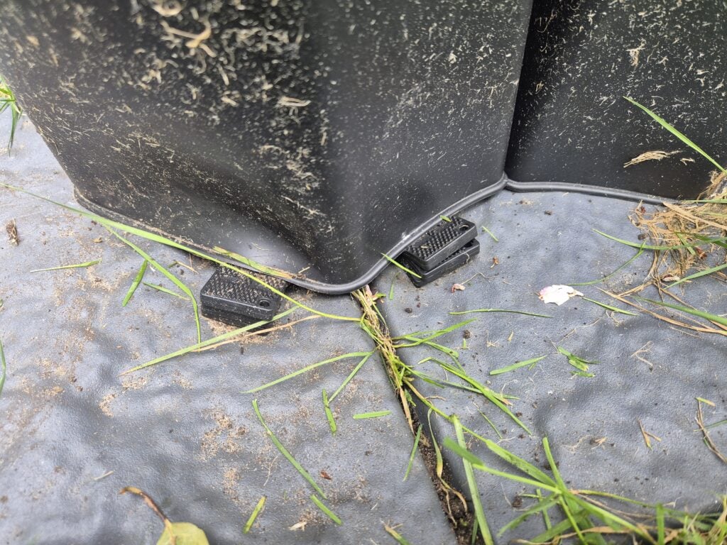 Spacers used to level a water butt on uneven ground
