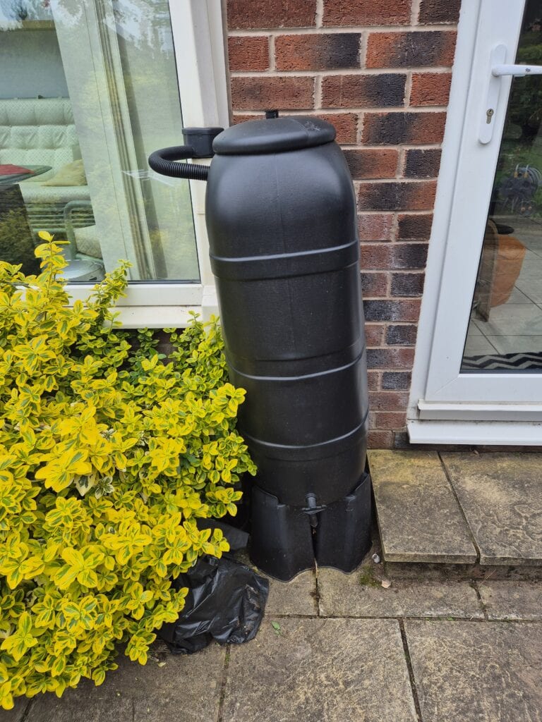 Water butt leaning due to uneven base in UK garden