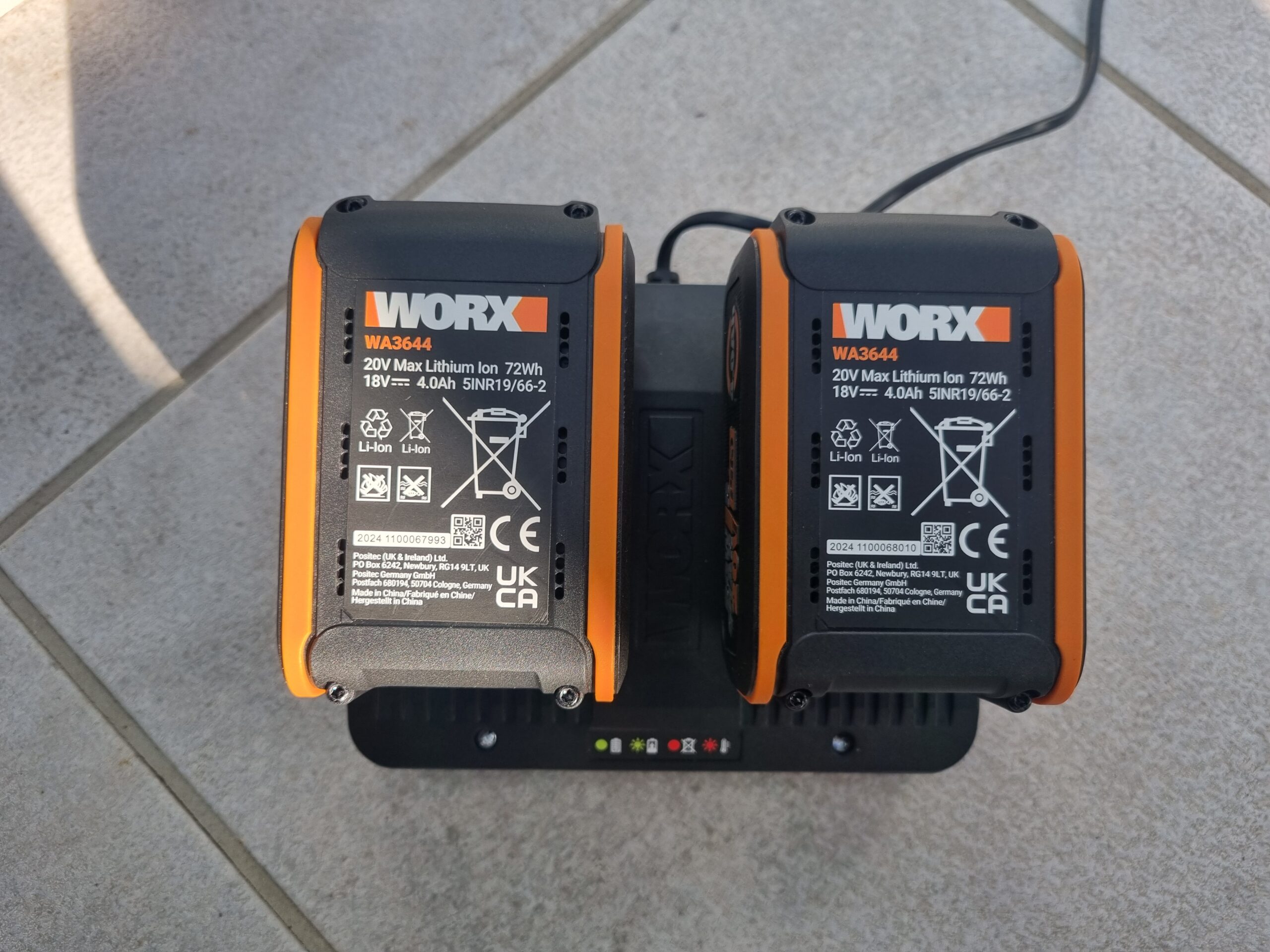 power share battery systems. Image is of a worx power share battery charger with 2 lithium batteries.