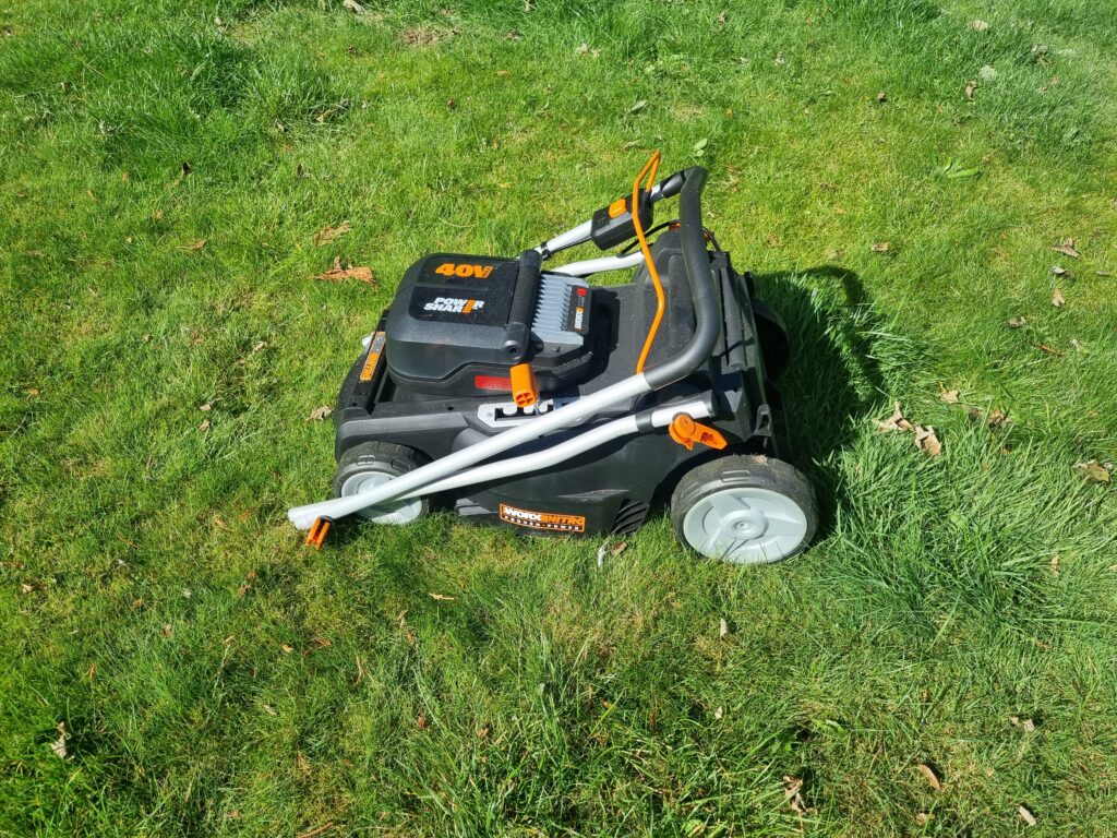 Worx WG737E cordless lawn mower folded for compact storage in UK garden
