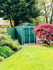 An example of a plastic garden shed in a UK garden.
