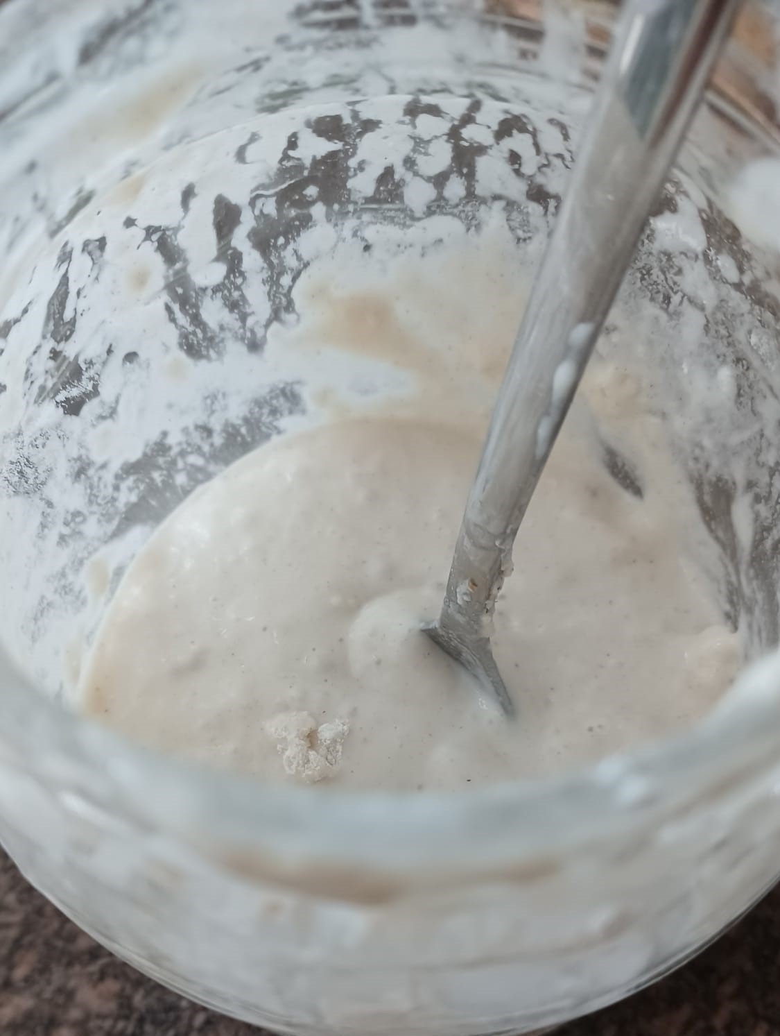 How to make a sourdough starter – bubbling starter mixture in glass jar