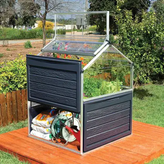 Palram Plant Inn 4x4 raised bed mini greenhouse in a small garden