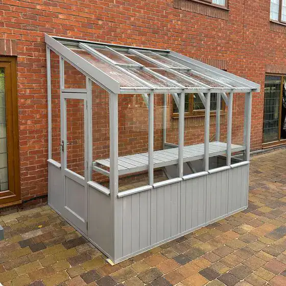 Coppice Hatfield 6x4 lean-to greenhouse with timber frame and glass panels in a UK garden