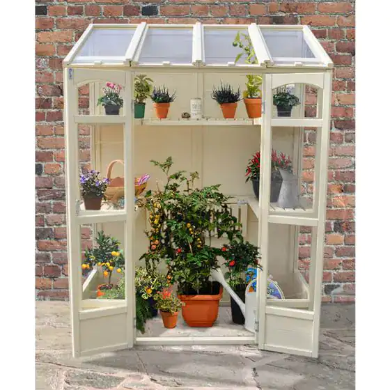 Forest Victorian tall wall mini greenhouse in a UK garden