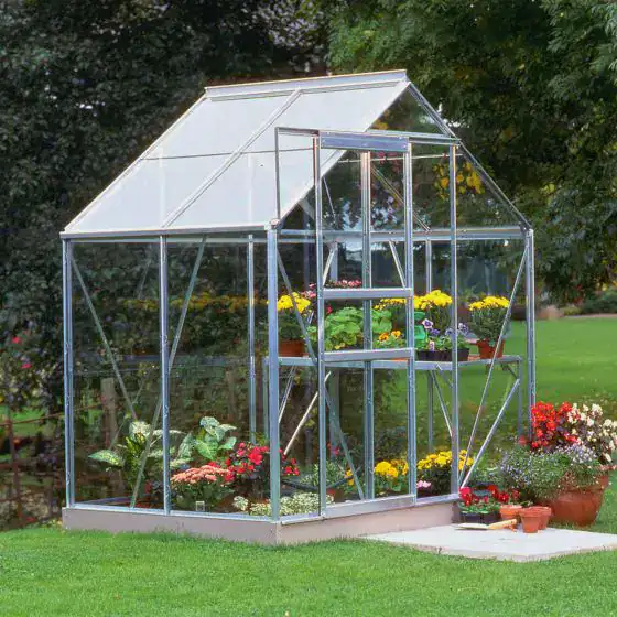 Halls Popular 6x4 glass greenhouse with aluminium frame in a UK garden