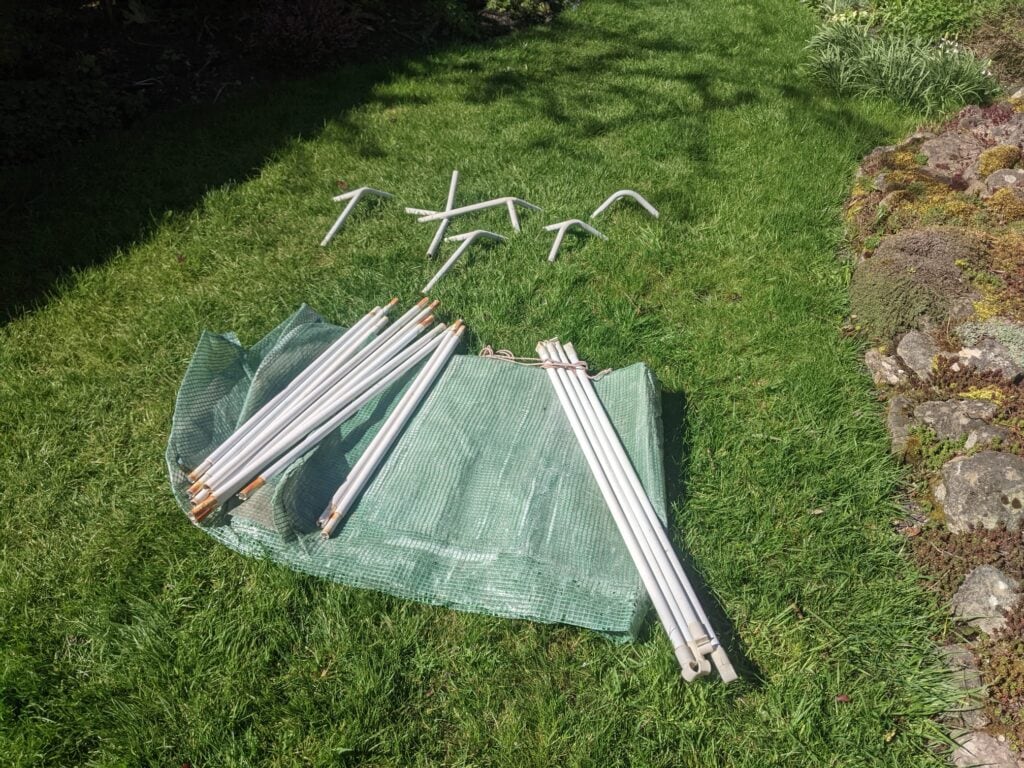 mini greenhouse parts laid out before assembly