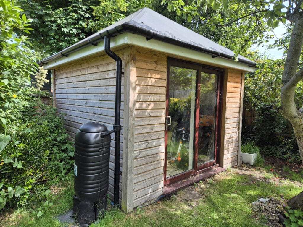 Wooden shed maintenance example showing untreated external timber after four years